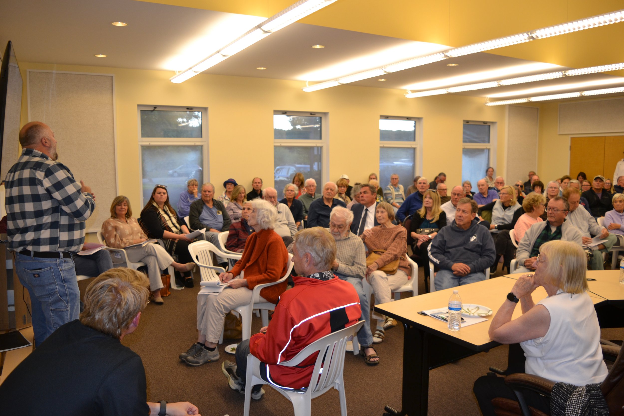 Group photo showing attendees listen to a presentation