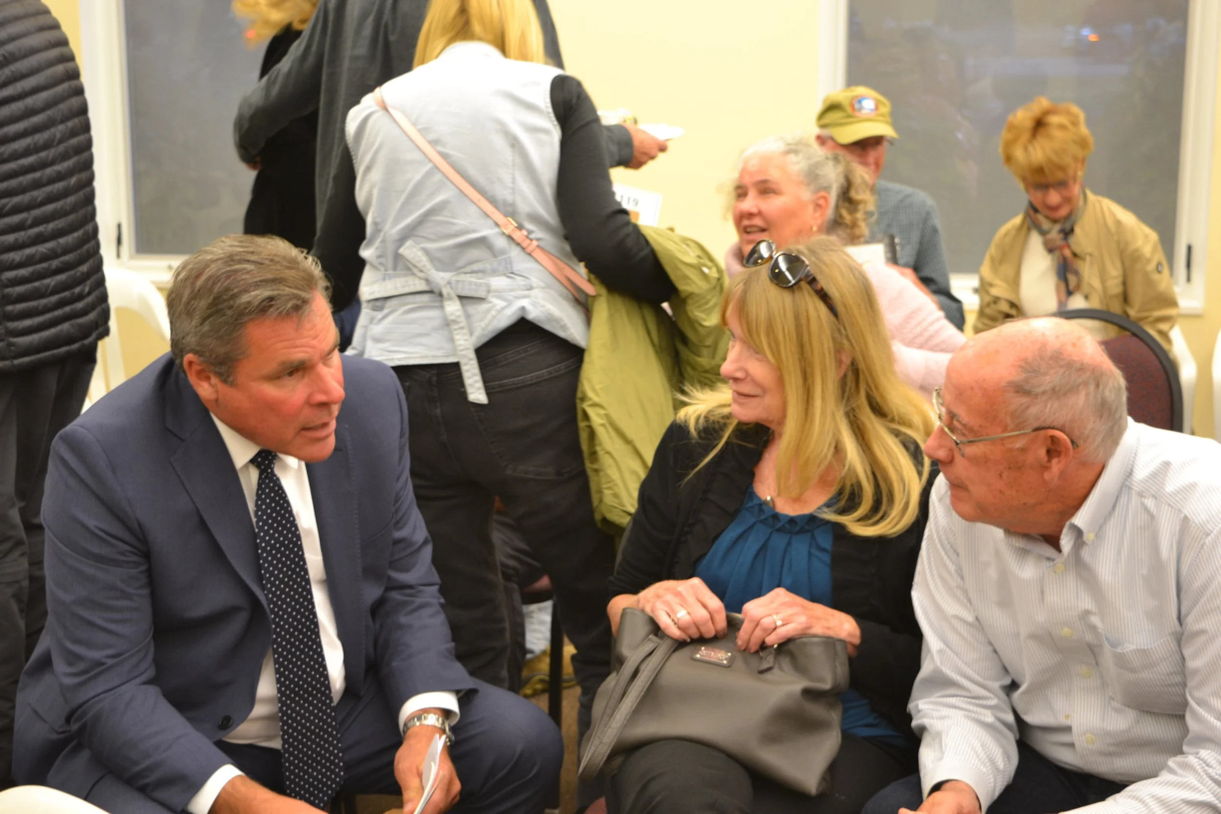 Senator Damoose talking with other attendees prior to the presentations.