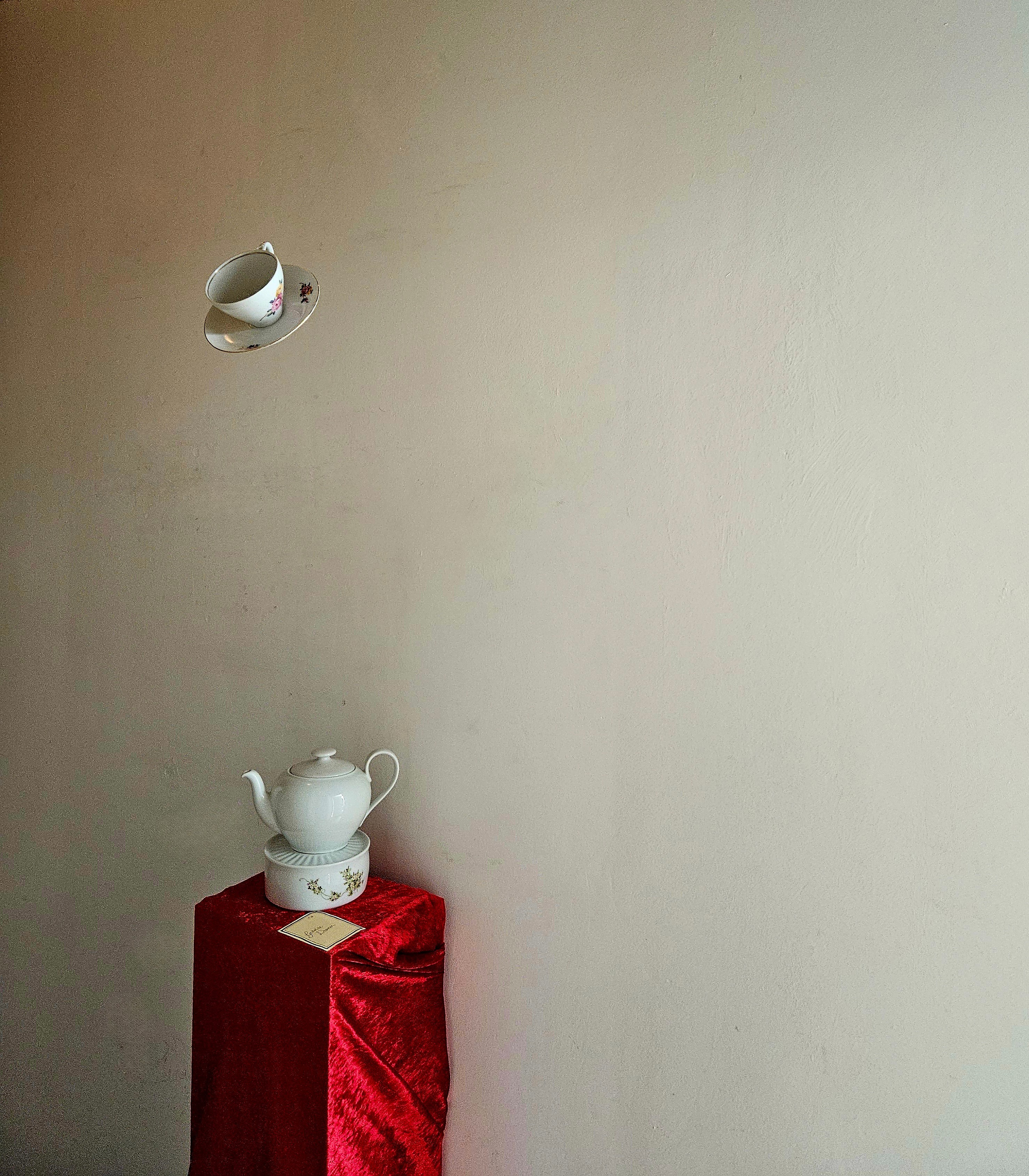 Surrealistic scene with flying teacup and mysterious teapot
