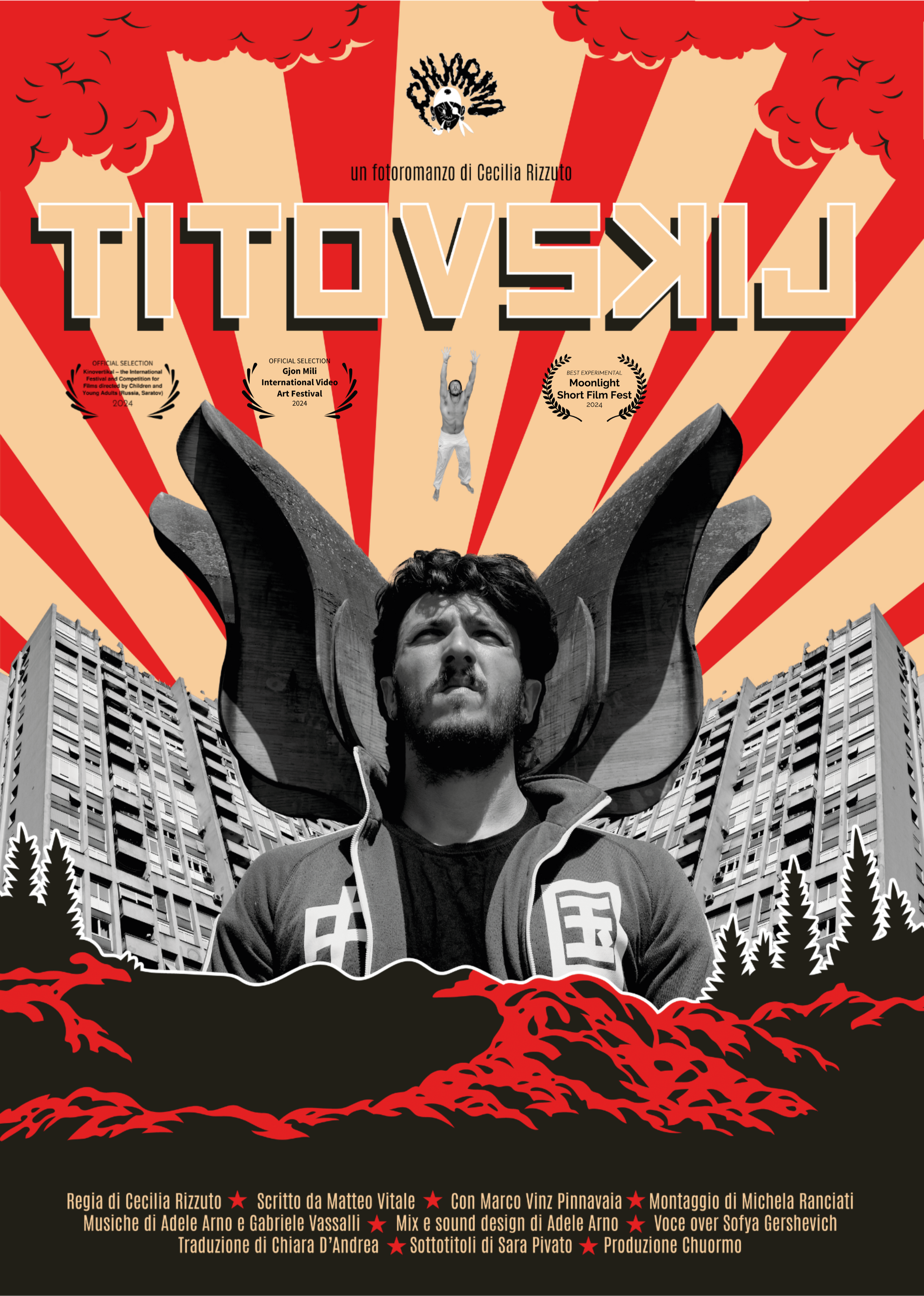 A promotional poster featuring a male figure with a serious expression, in front of a large flower or organic sculpture, with buildings and trees in the background. The poster has a red and beige color scheme with rays emanating from the top.