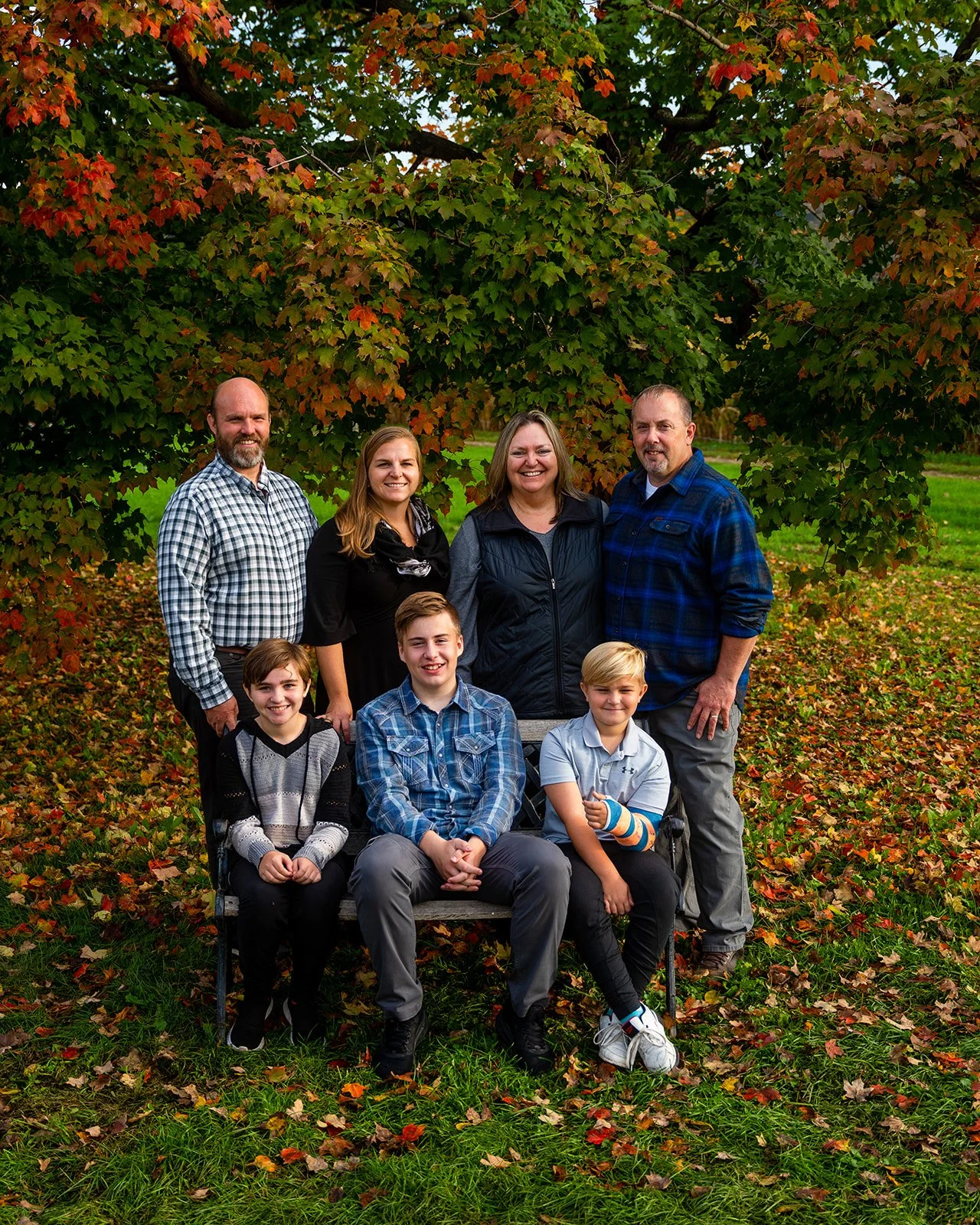 a family of seven smile for an outdoor fall portrait