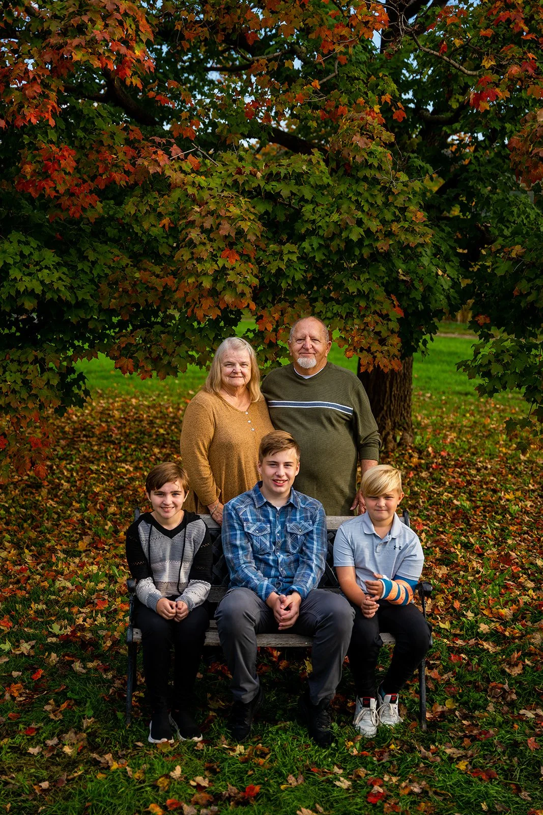 a grandmother and grandfather smile with their grandchildren