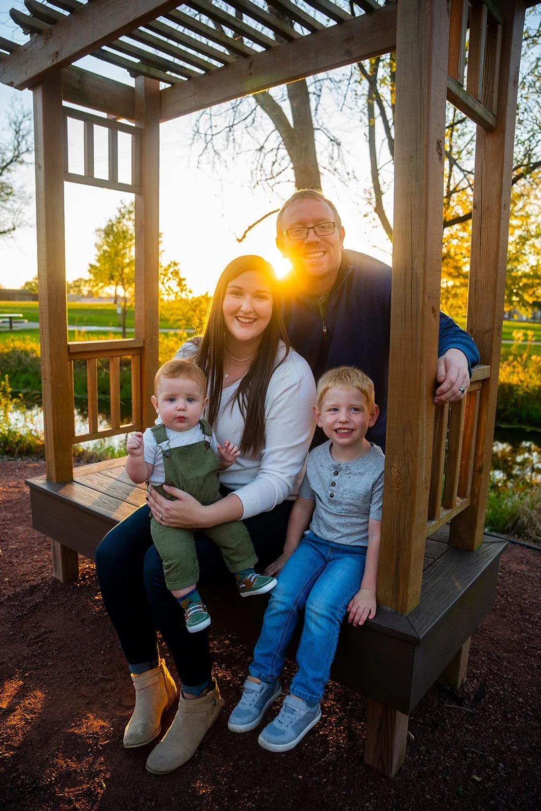 At sunset a family poses for a photo in the park
