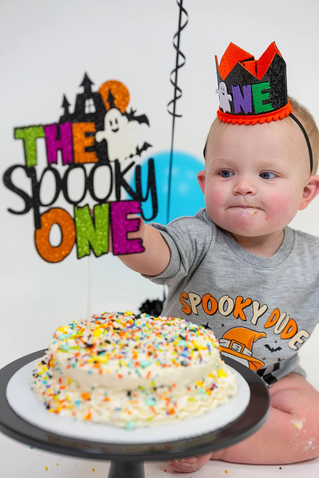 a young boy smashes his cake
