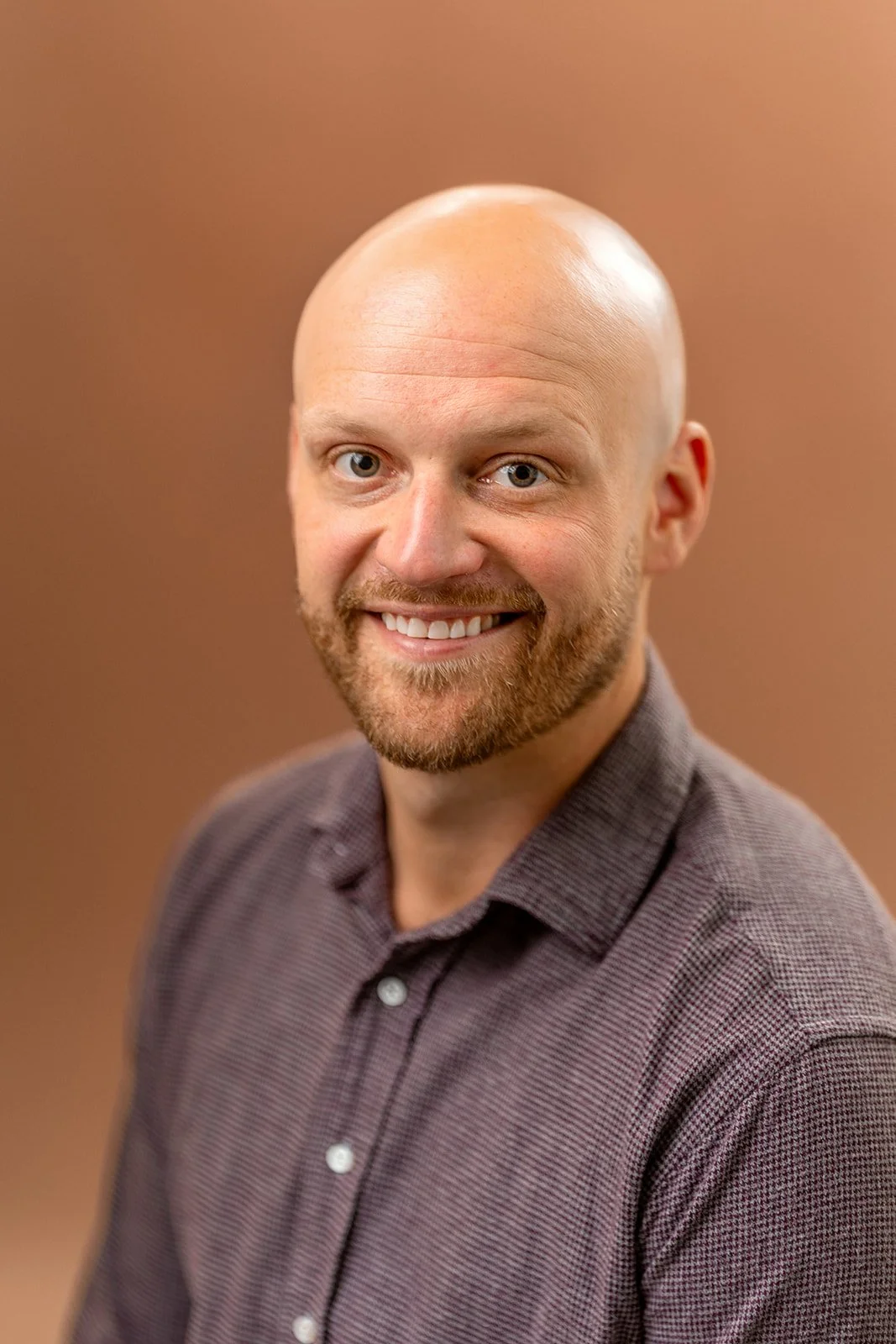 photo of a young man smiling for a studio portrait