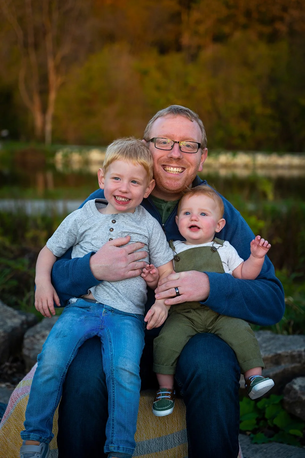 A happy man poses for a photo with his kids