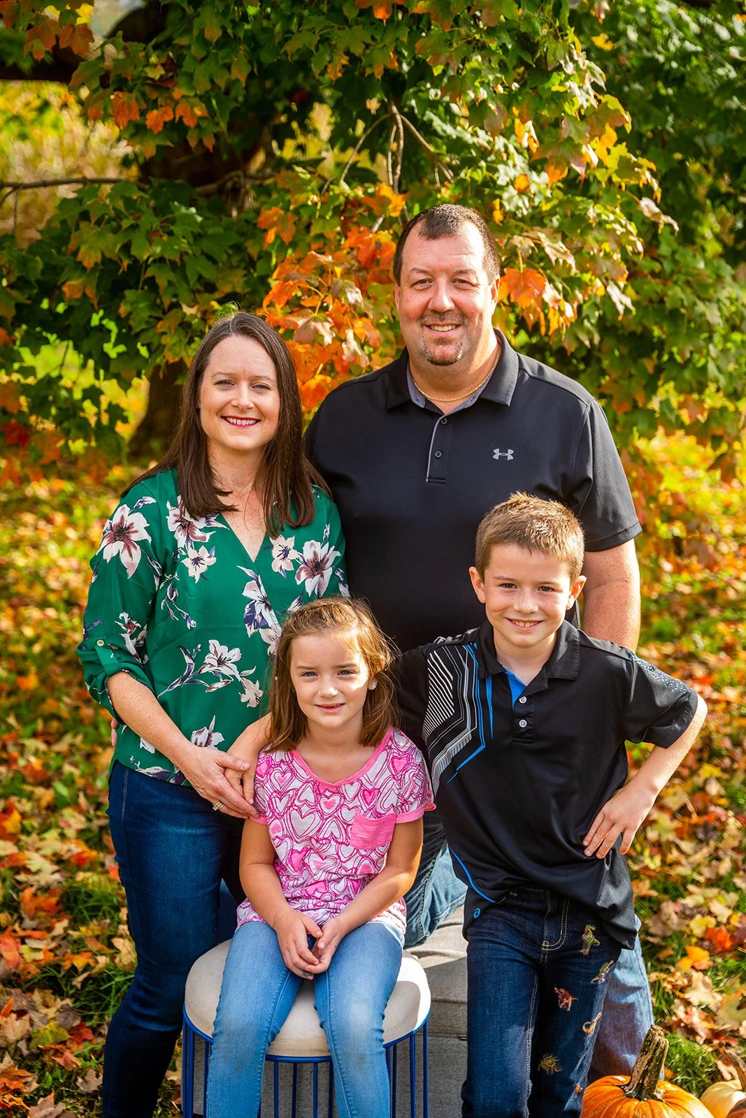 a family of five smiles for a fall family portrait