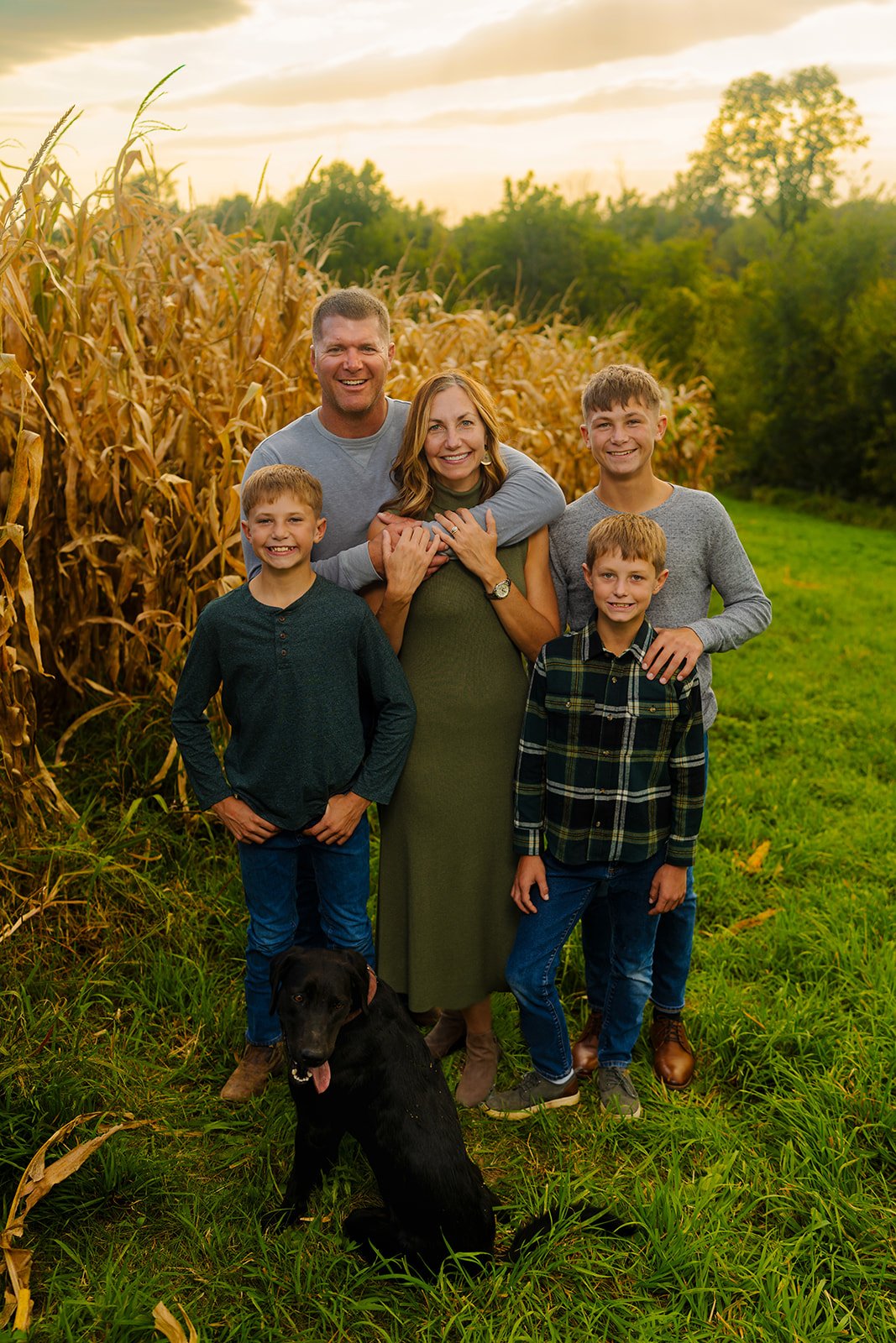 a family of five smiles on