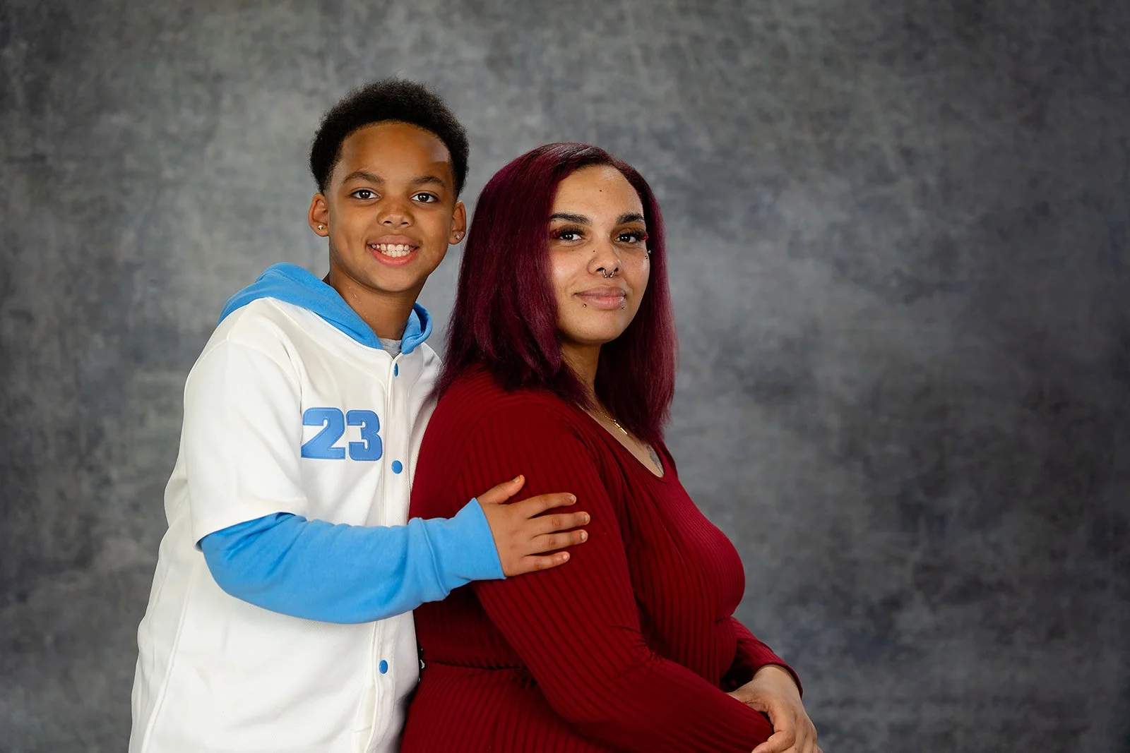a son and mother pose together for a studio photo