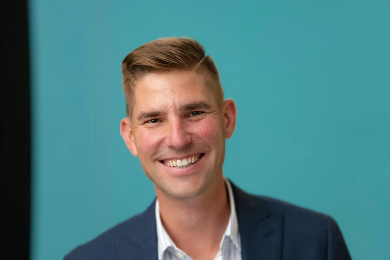 photo of an accountant smiling for a studio headshot