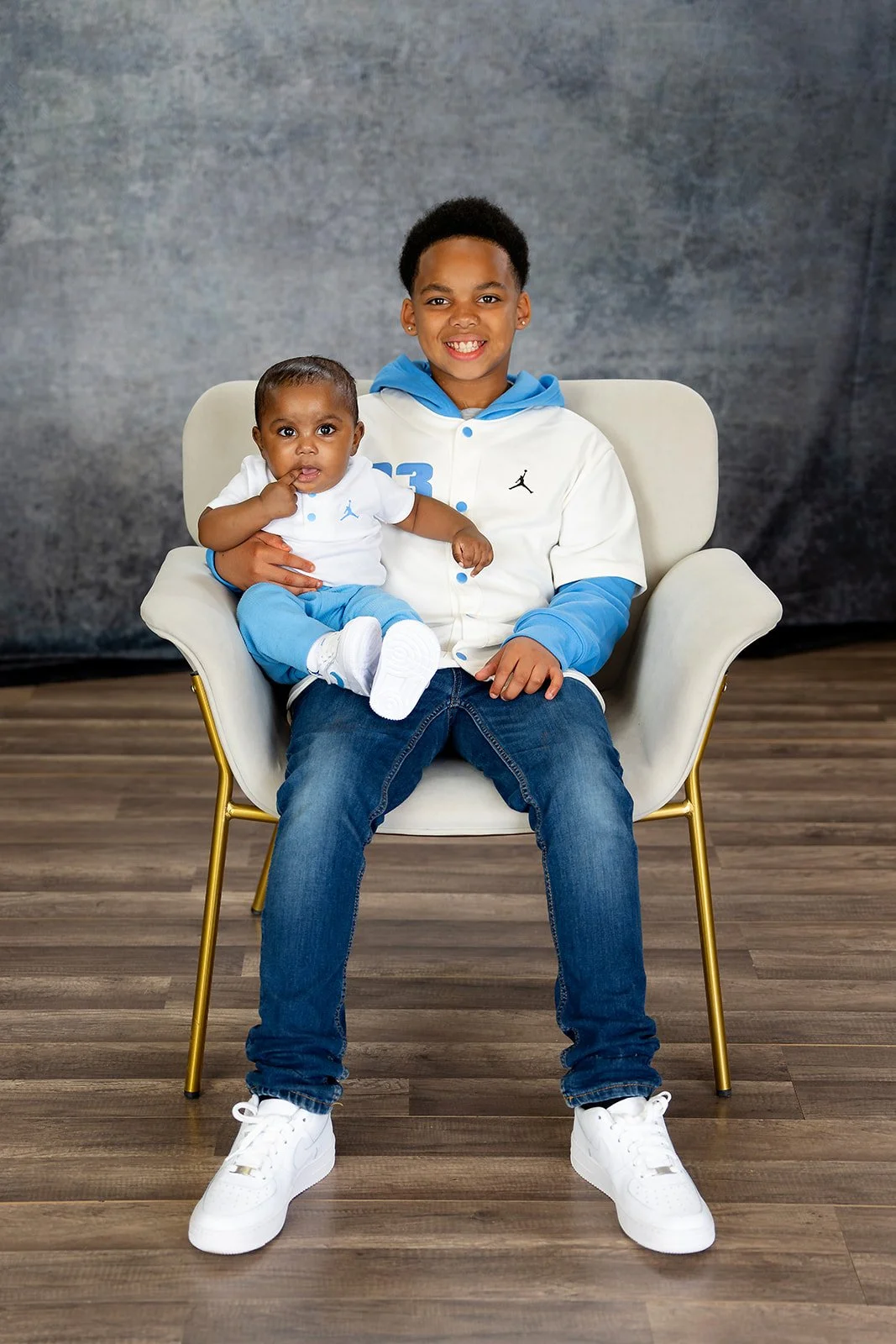 two brothers pose together for a studio portrait