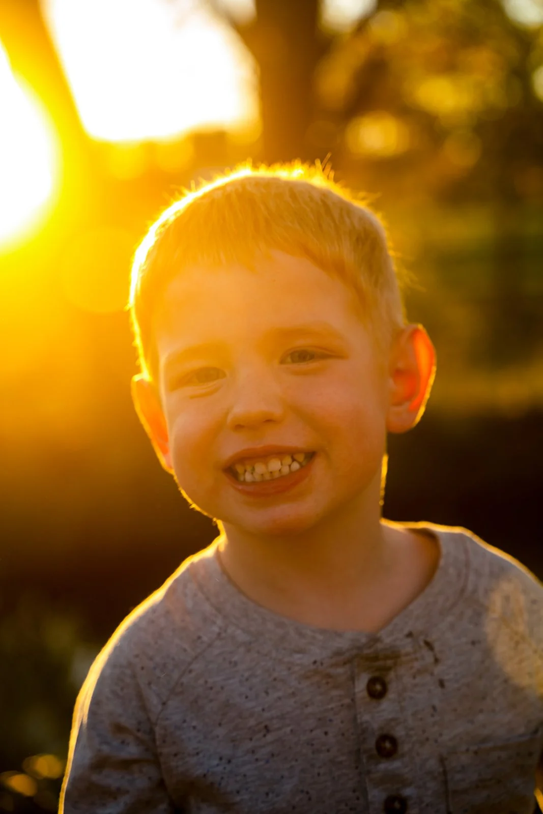 a young happy boy smiles for the camera