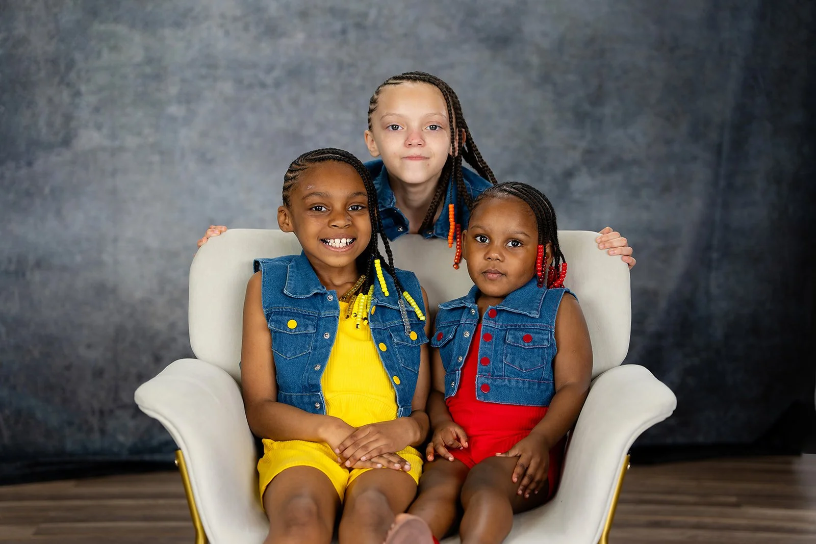 a young family poses for a studio portrait
