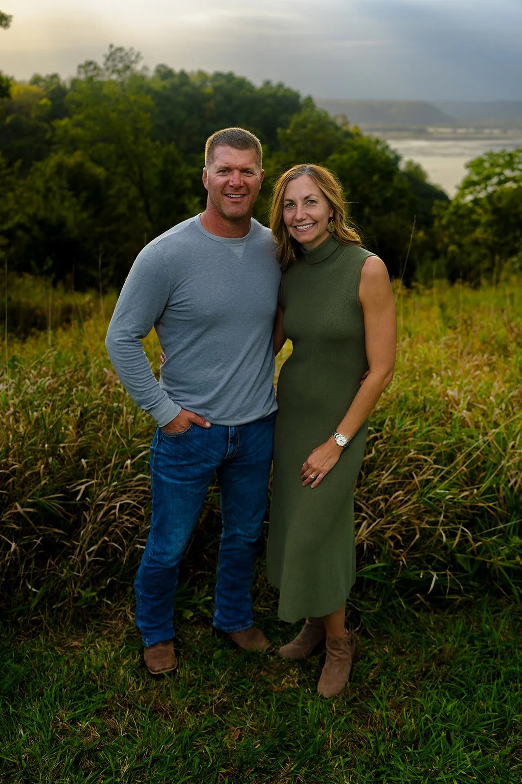 a young happy couple smile together for a family portrait