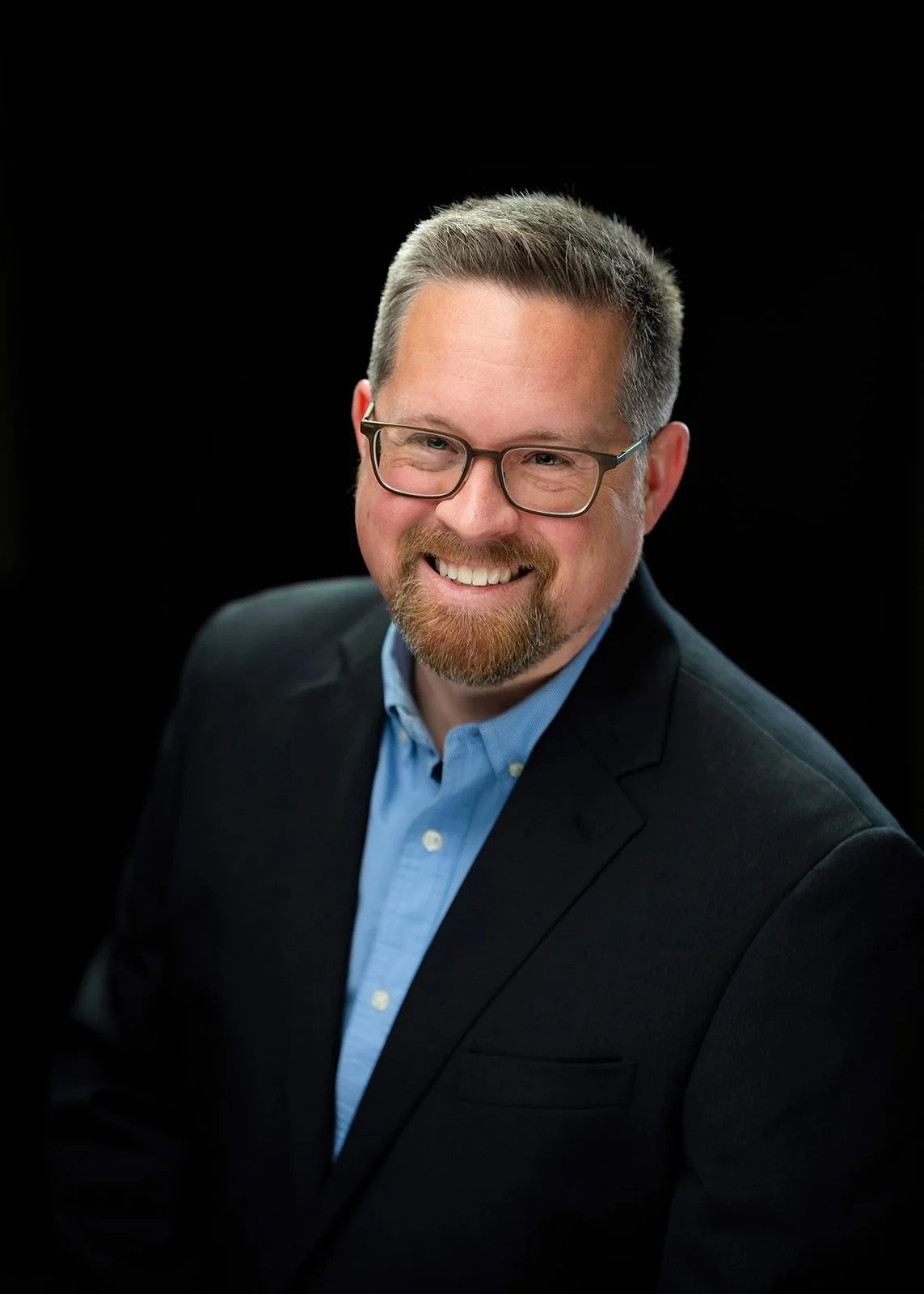 photo of a businessman posing for a studio portrait headshot