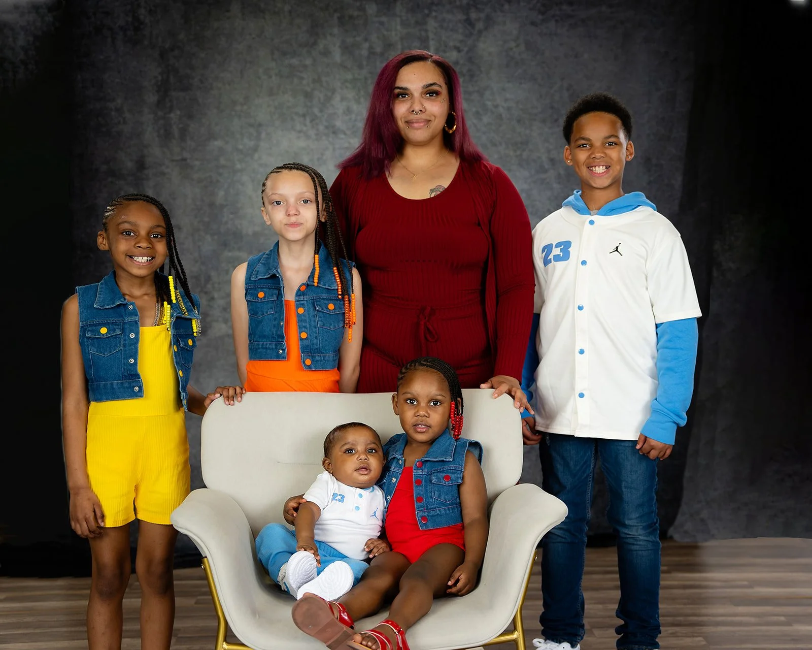 a family of six pose for a studio portrait