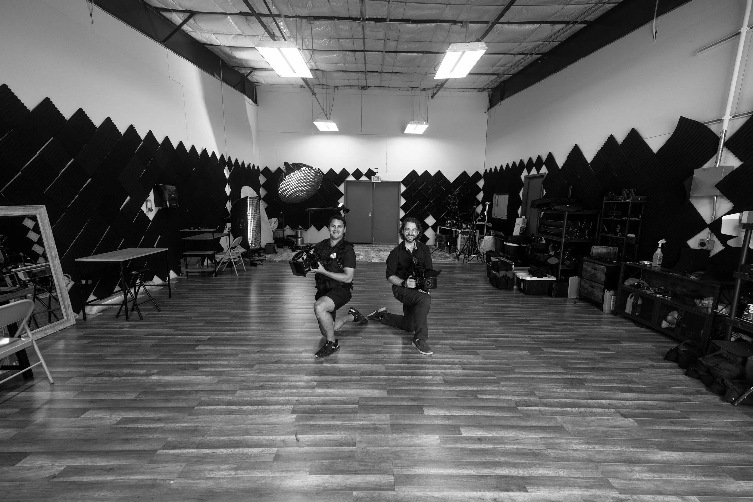 Ben Tierney-Morrison and Jacob Zabinski kneel in their studio at the Coulee Region Business Center in La Crosse, Wisconsin at 1100 Kane st. Blue Tie Productions and Morrison Media, LLC