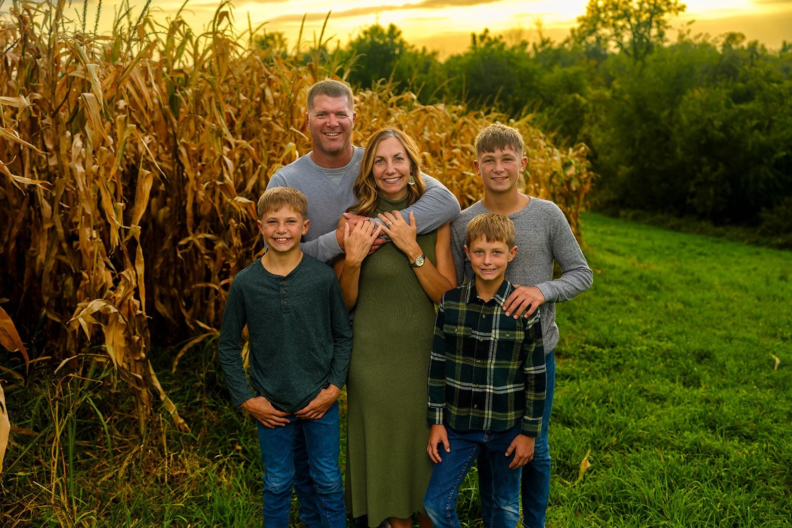 a family of five poses for a family portrait by their corn husks