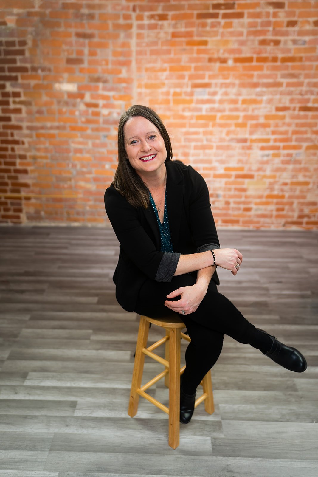 photo of a smiling business woman posing for a studio headshot