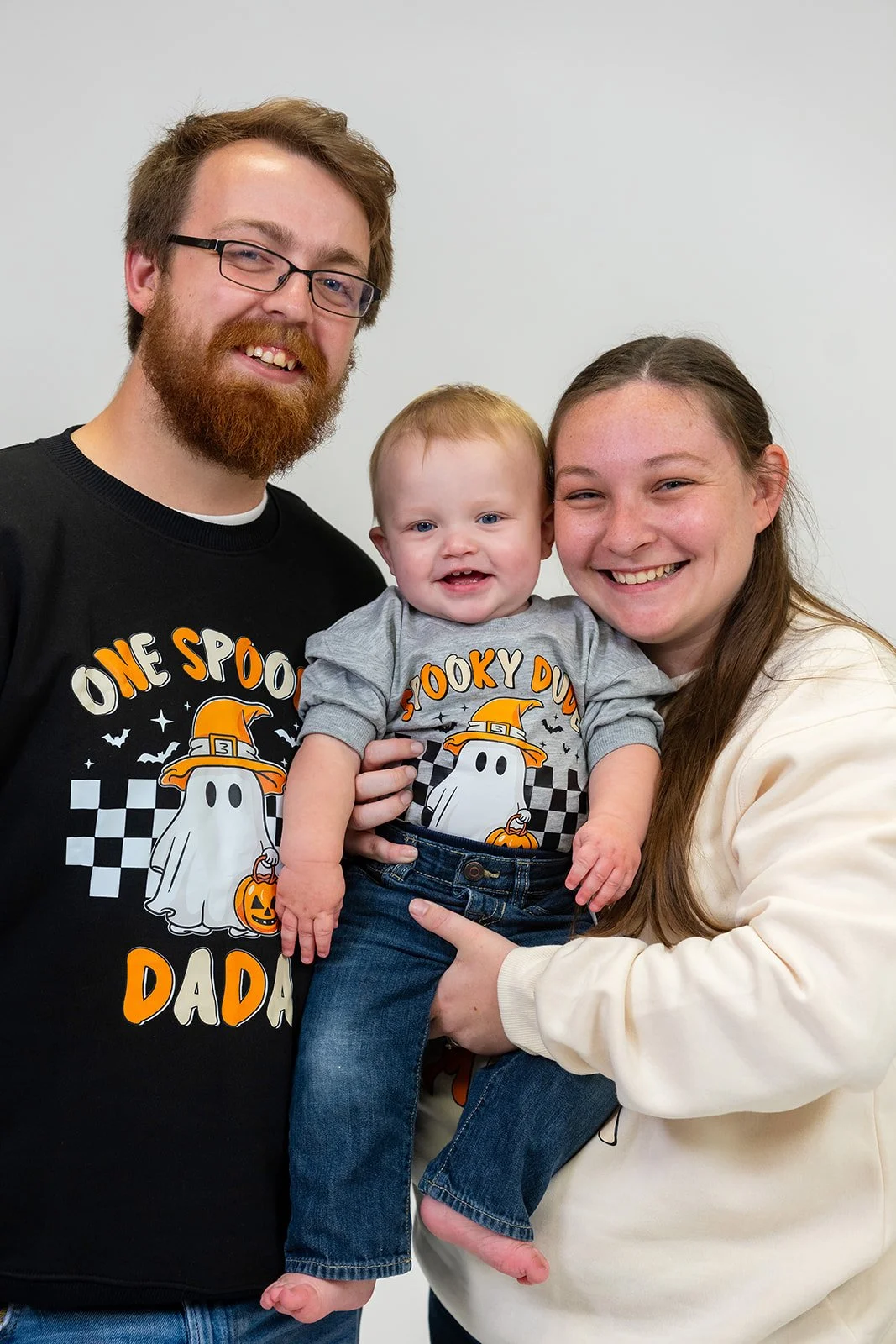 a young family smiles for a photoshoot in La Crosse, Wisconsin