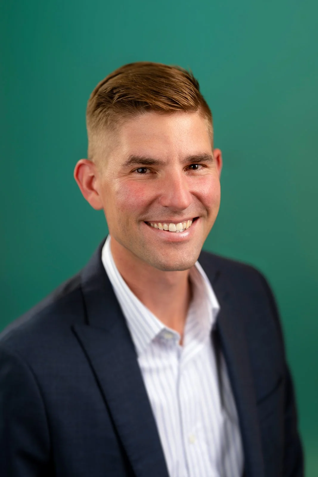 photo of a handsome young accountant posing for a studio headshot