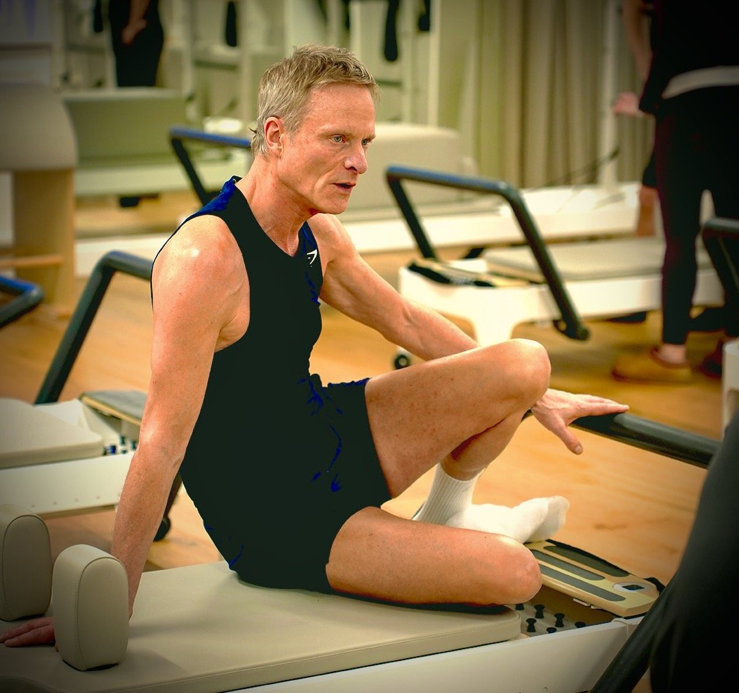 Max Howarth seated on a Reformer at Luma Pilates Edinburgh