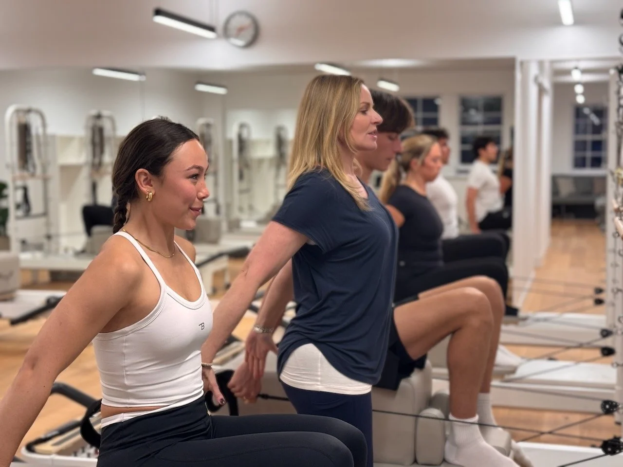 Lucia Poulter cueing clients on the long box during a Reformer Pilates class at Luma Pilates, Edinburgh
