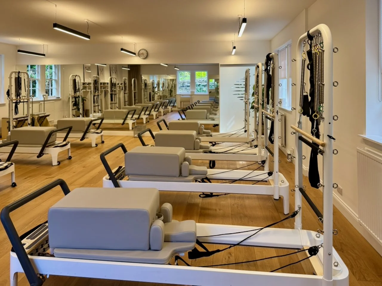 Reformer Pilates studio at Luma Pilates, Edinburgh New Town, showing a row of Reformers with Tower apparatus