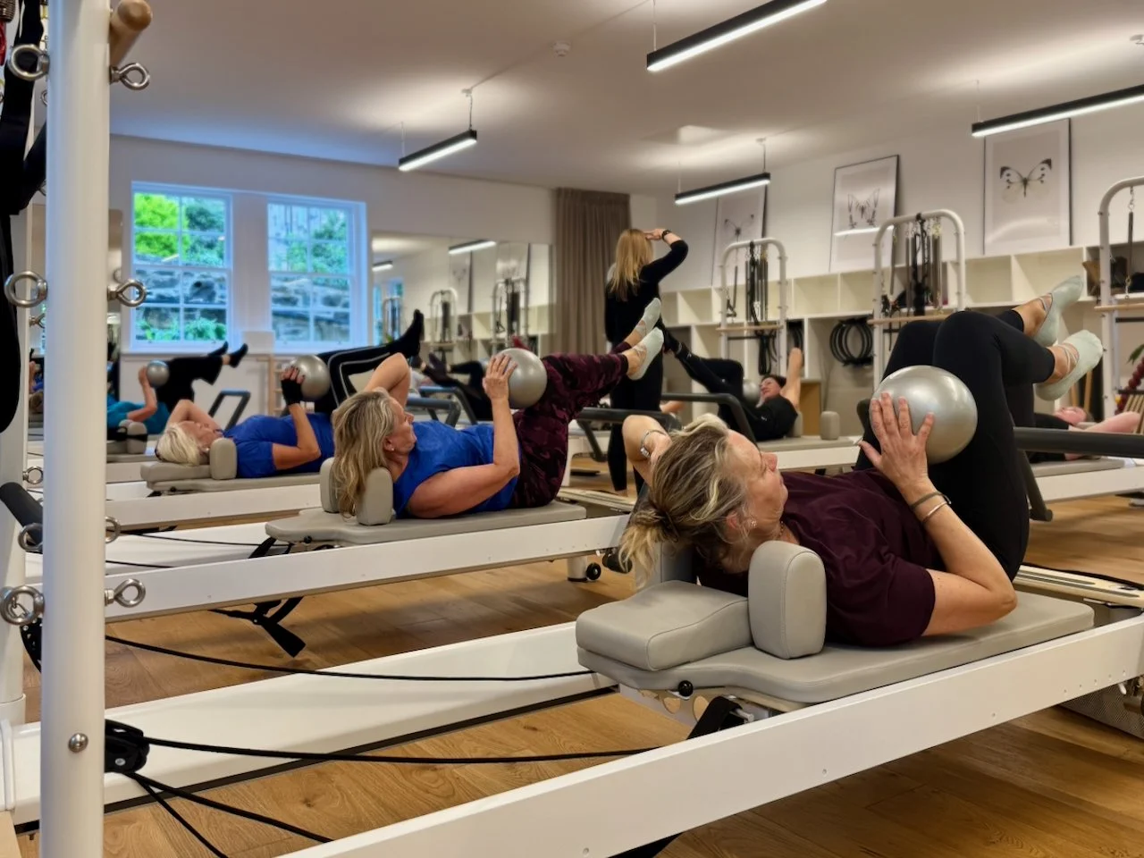 Group Reformer Pilates class using soft balls at Luma Pilates, Edinburgh