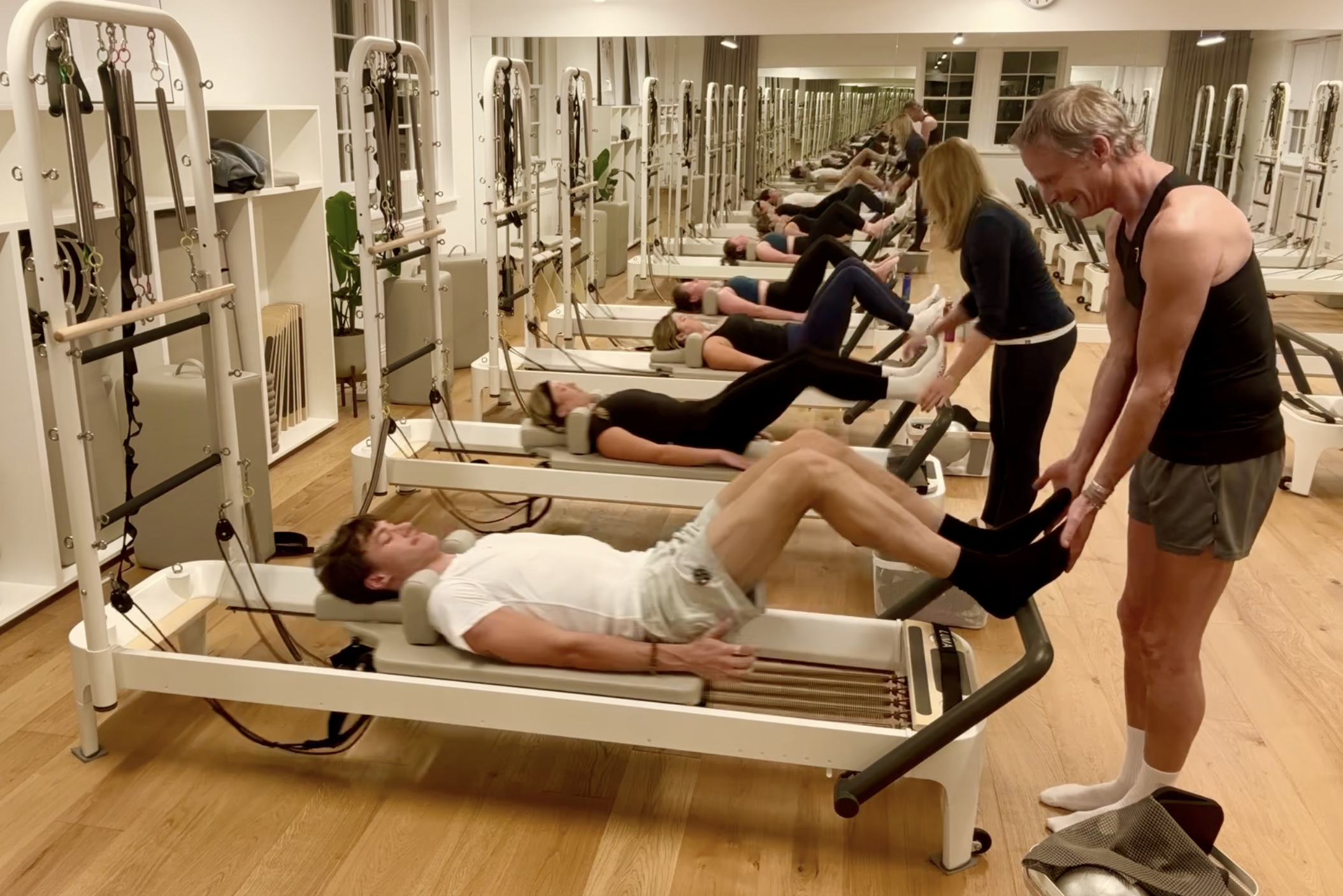 Instructors and clients in a Reformer Pilates class at Luma Pilates, Edinburgh