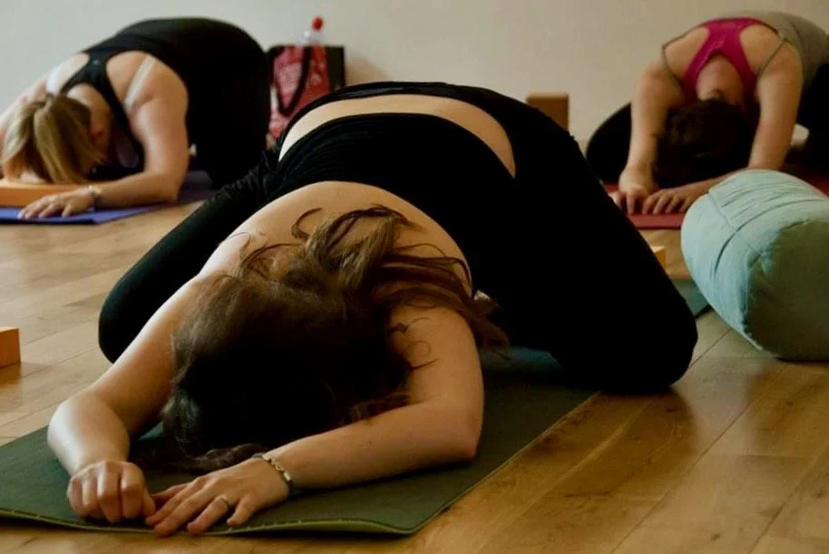 Clients in child's pose during a second trimester Yoga class led by Kat Aydin at Luma Pilates Edinburgh