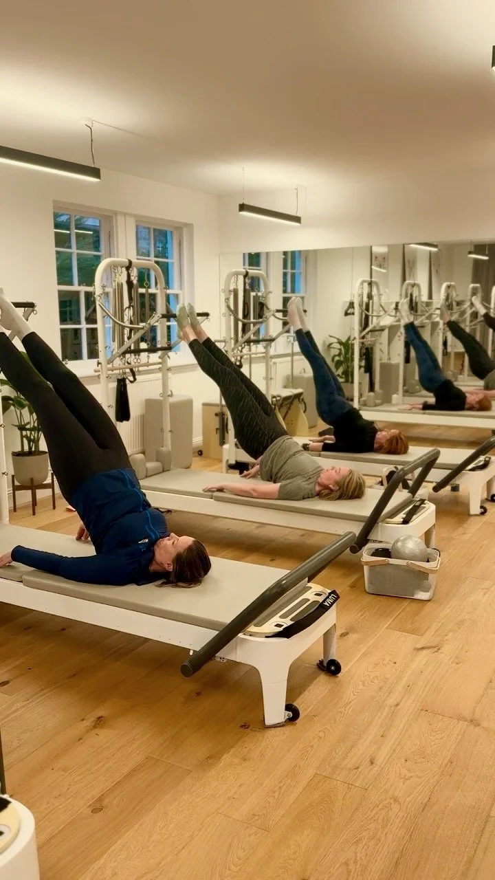 Students on Reformer machines during a Level 2 Pilates class at Luma Pilates, Edinburgh