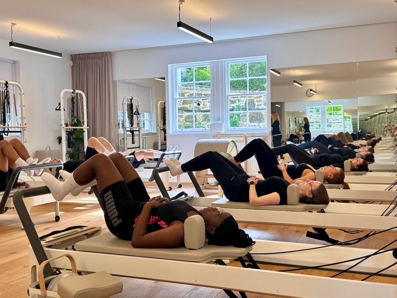 A group Reformer Pilates class during footwork at Luma Pilates, Edinburgh