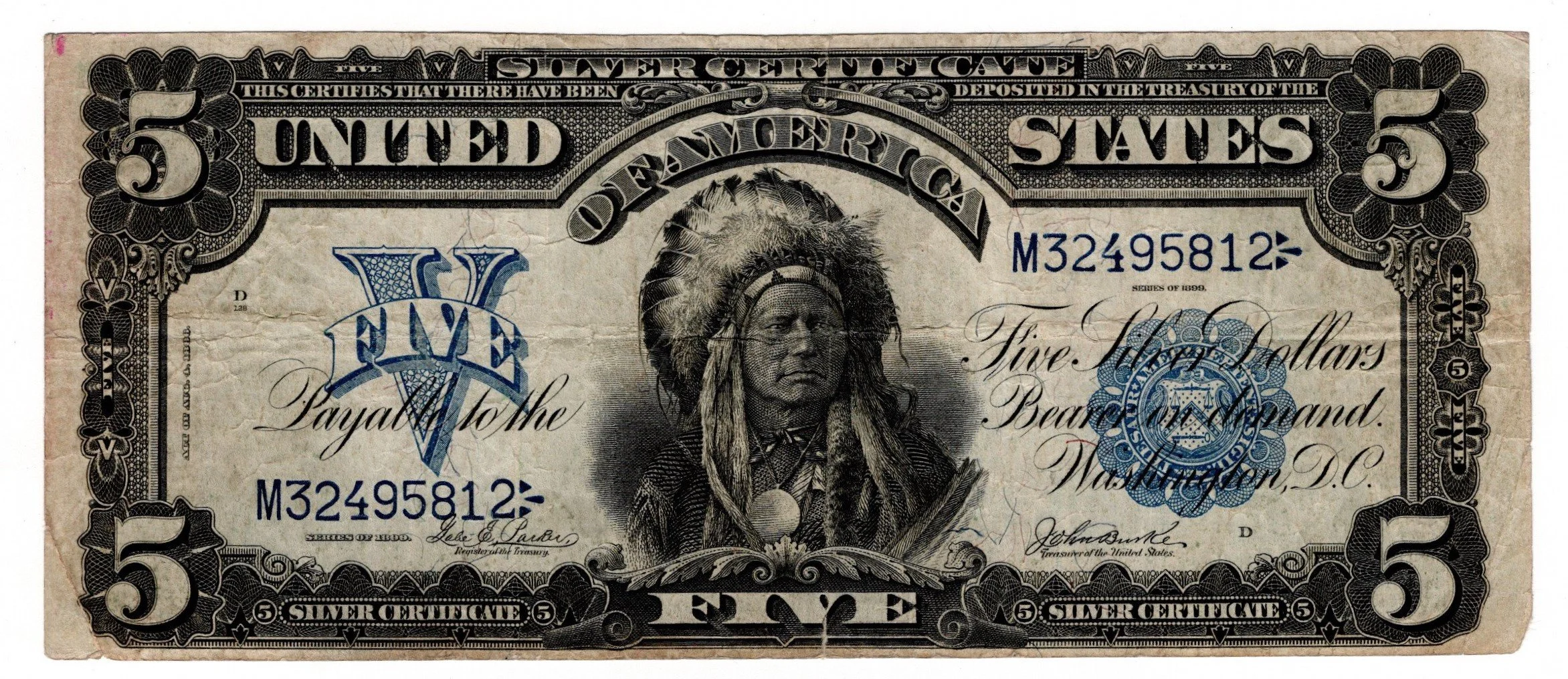 A worn five dollar bill featuring a portrait of a Native American in a headdress at the center, with decorative black and gray borders and blue and black text.