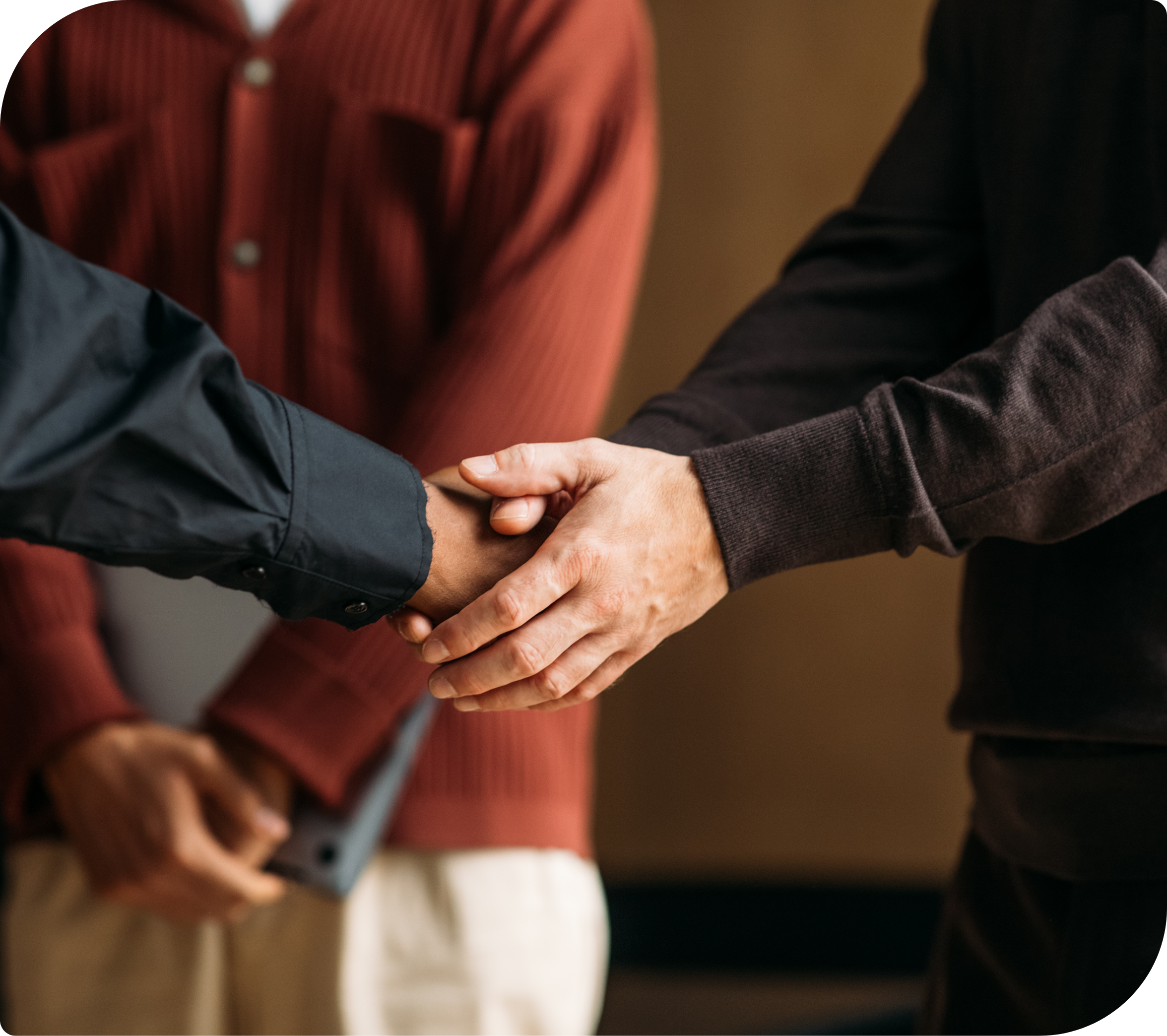Two people grasping hands representing collaboration and partnership in financial support