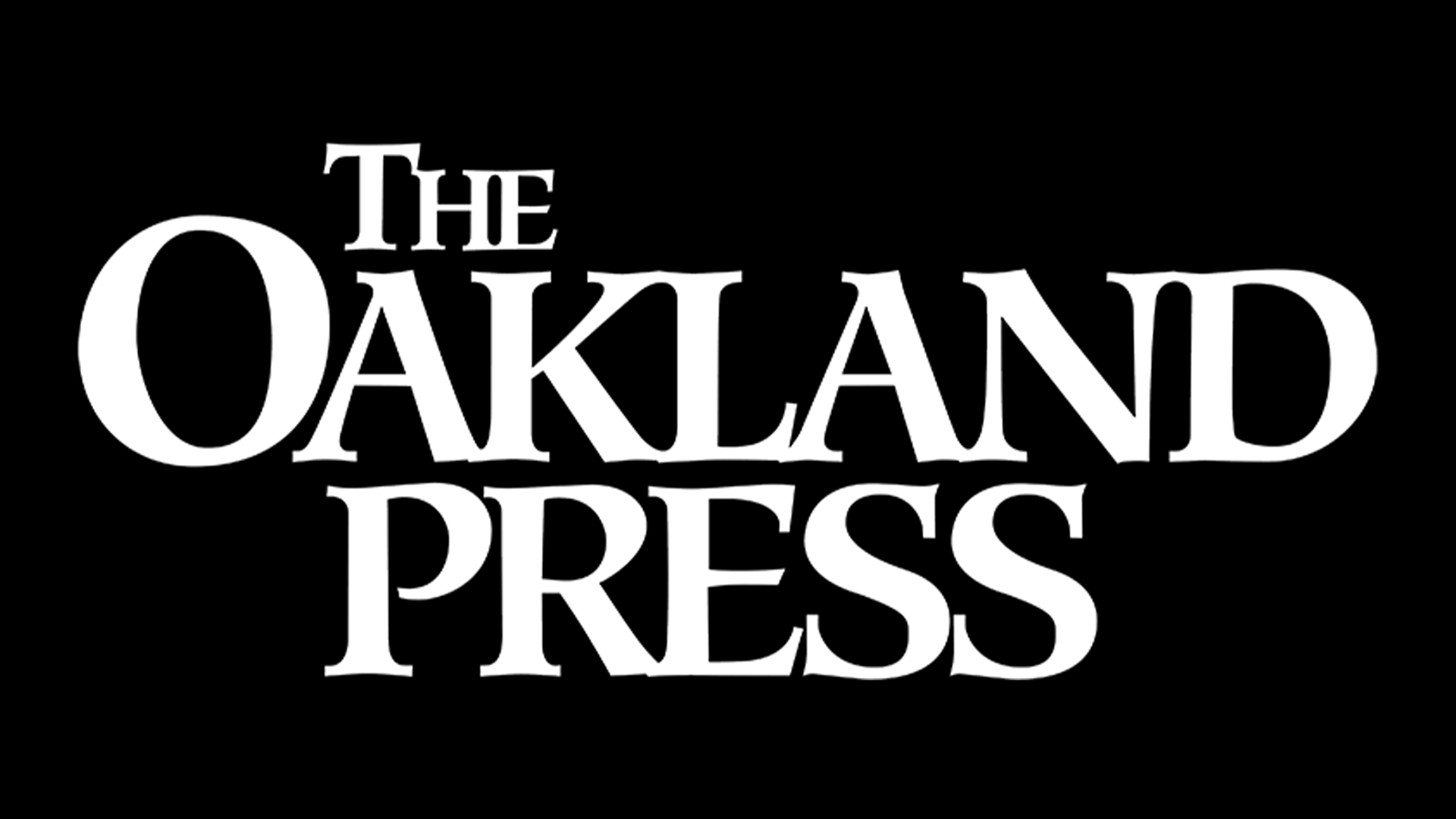 Black background with white text reading 'The Oakland Press' in stylized font.