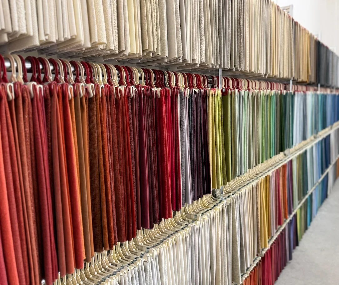 upholstery fabric samples in a wide range of colors displayed in showroom