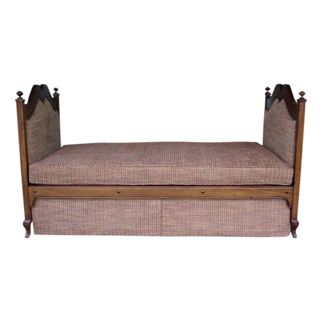 Antique wooden daybed with cushioned seat and high-back sides, upholstered in upholstery fabric with a plaid pattern.