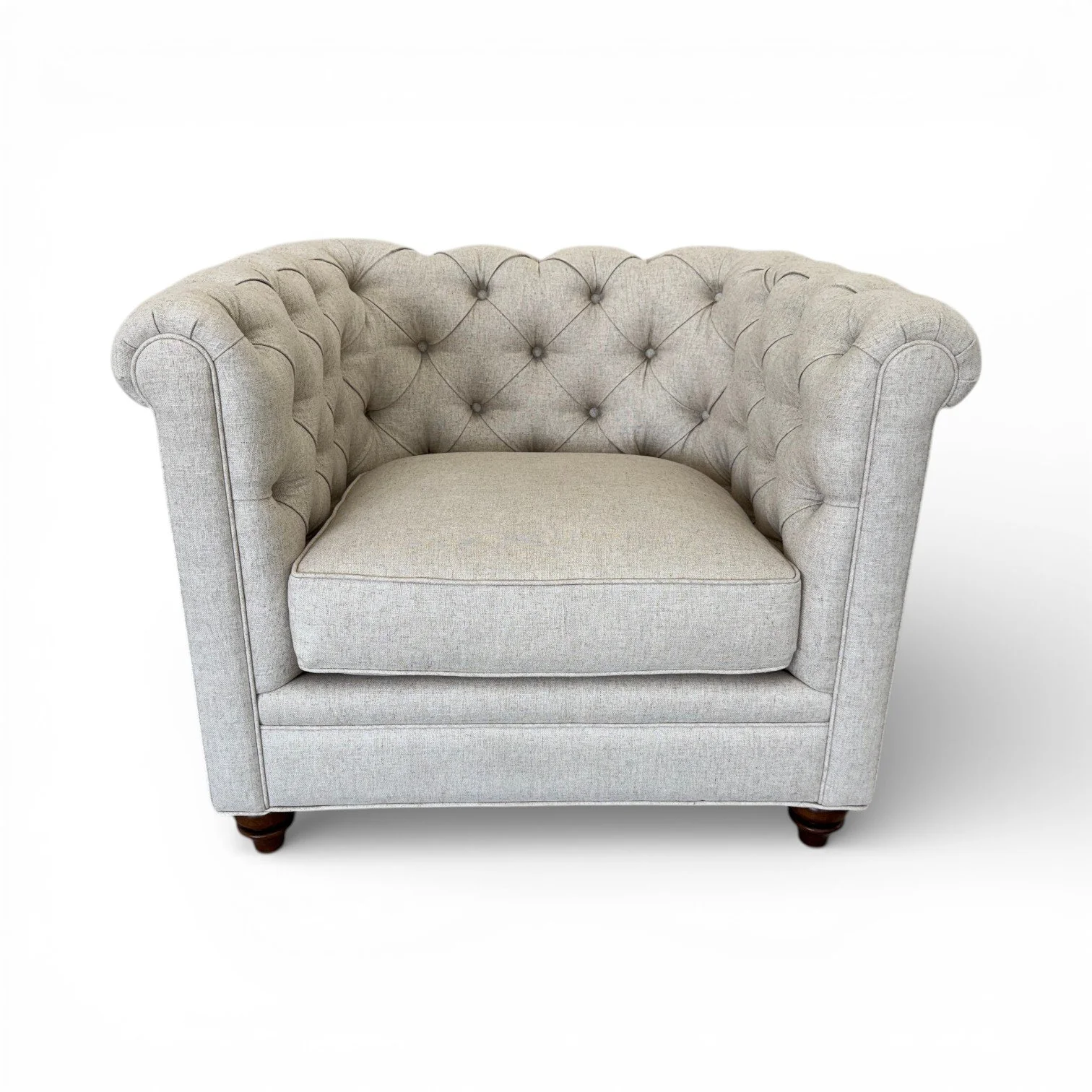A light gray upholstered armchair with a tufted backrest and rolled arms, set against a plain white background.