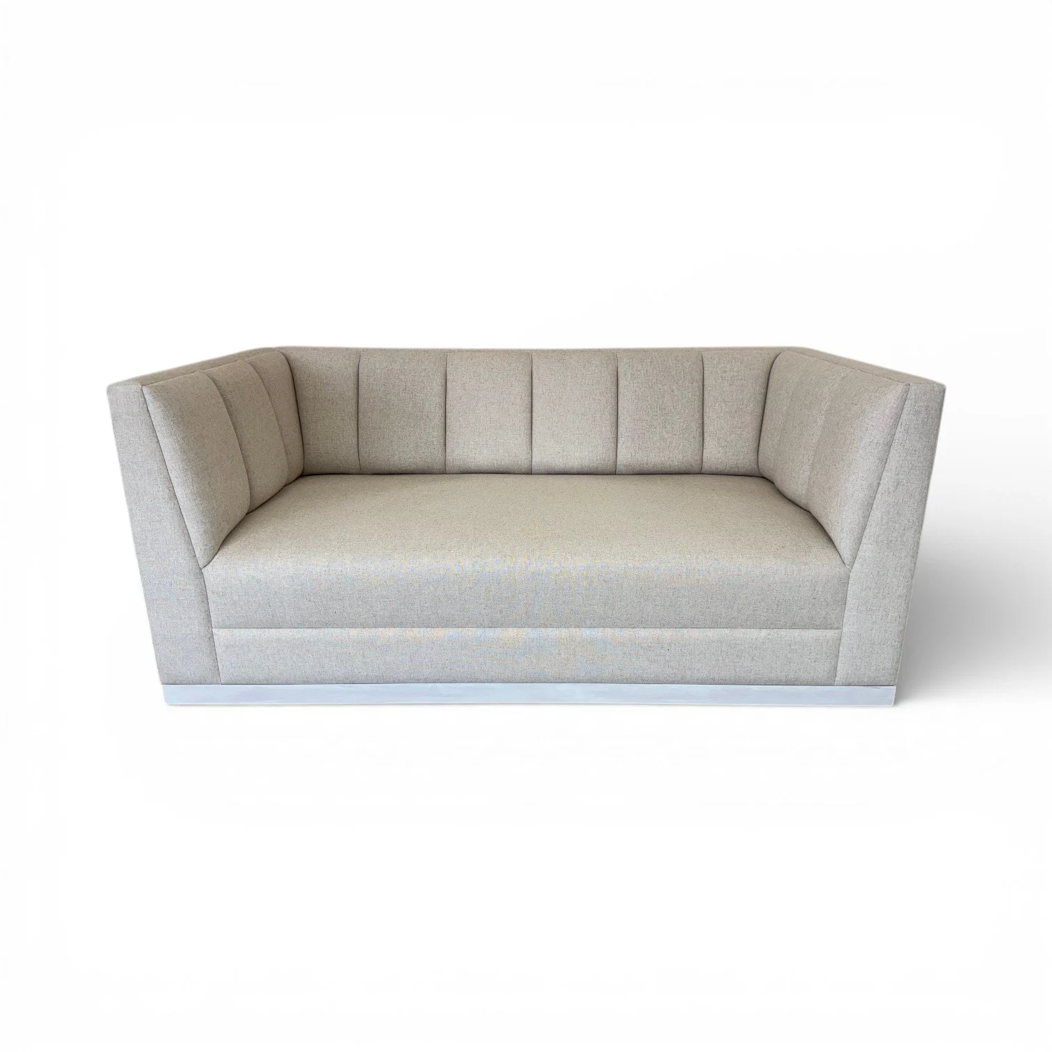 Light gray upholstered sofa with high arms, vertical stitching, and a boxy shape.