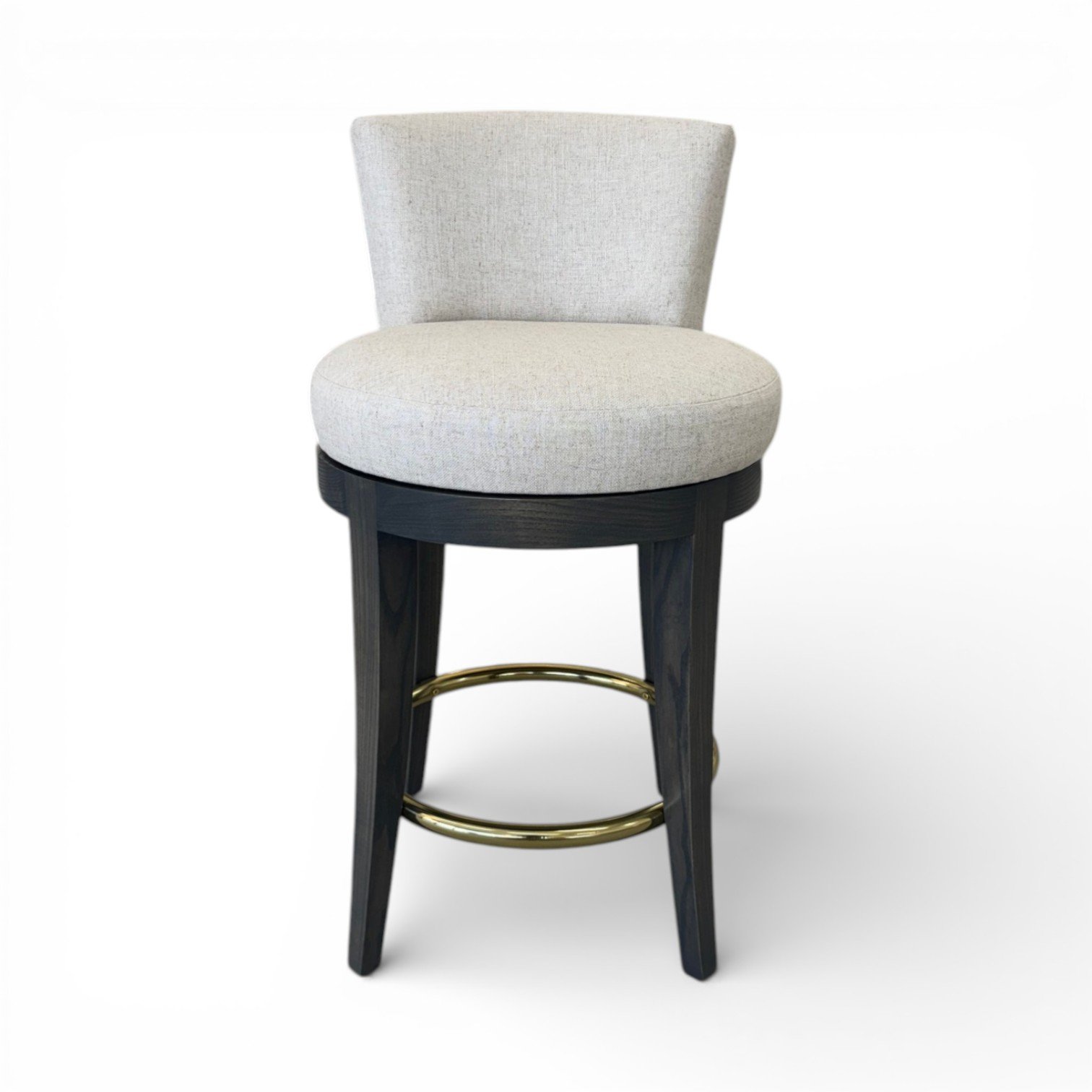 A modern barstool with a light gray upholstered circular seat and backrest, black wooden legs, and a gold metal footring.