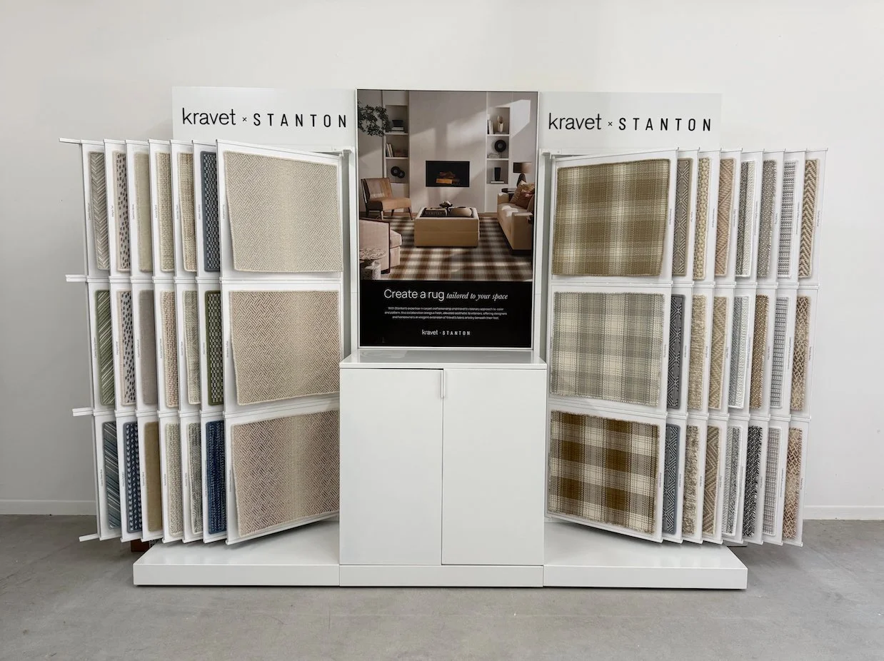 carpet and rug samples displayed on showroom racks for material selection