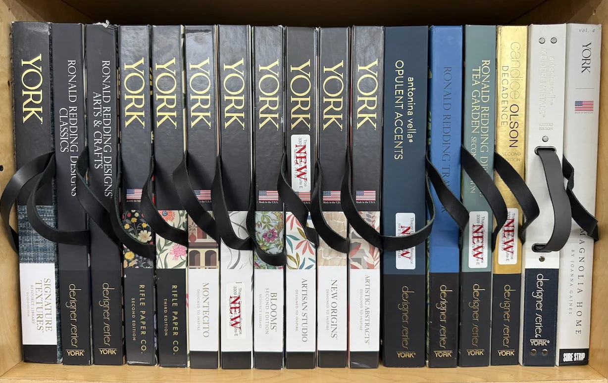 wallpaper sample books displayed with a variety of patterns and designs