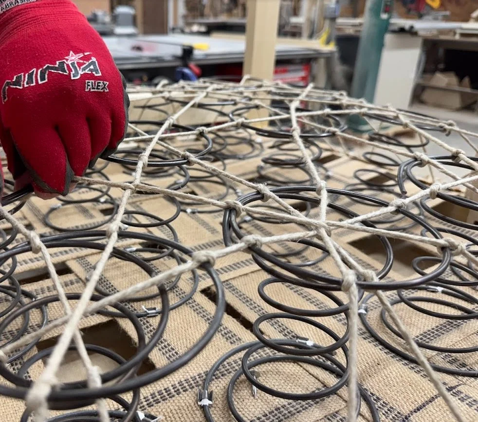 furniture seat springs and webbing being repaired during upholstery restoration