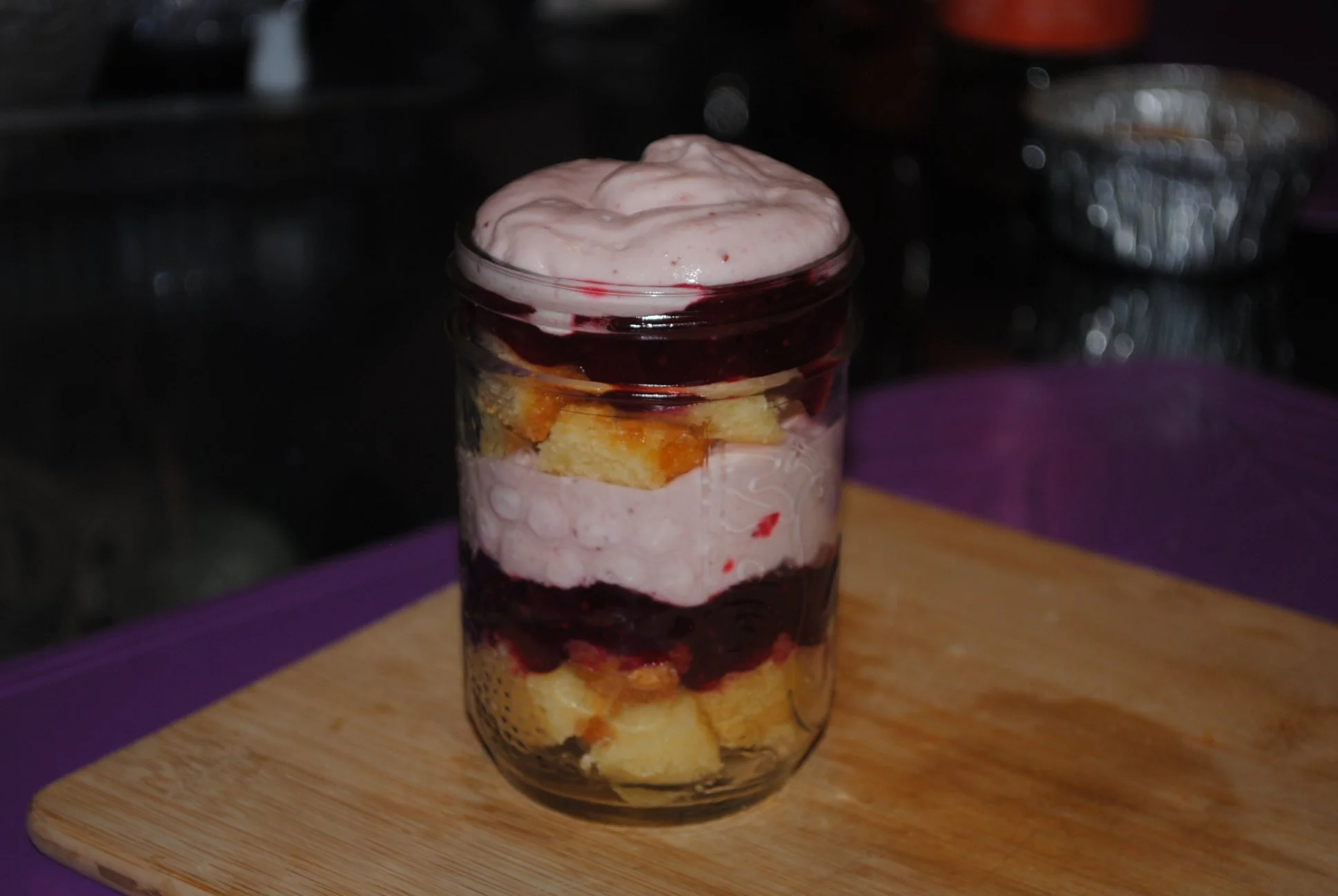 cake jar with pound cake layered with a cranberry compote and strawberry mousse