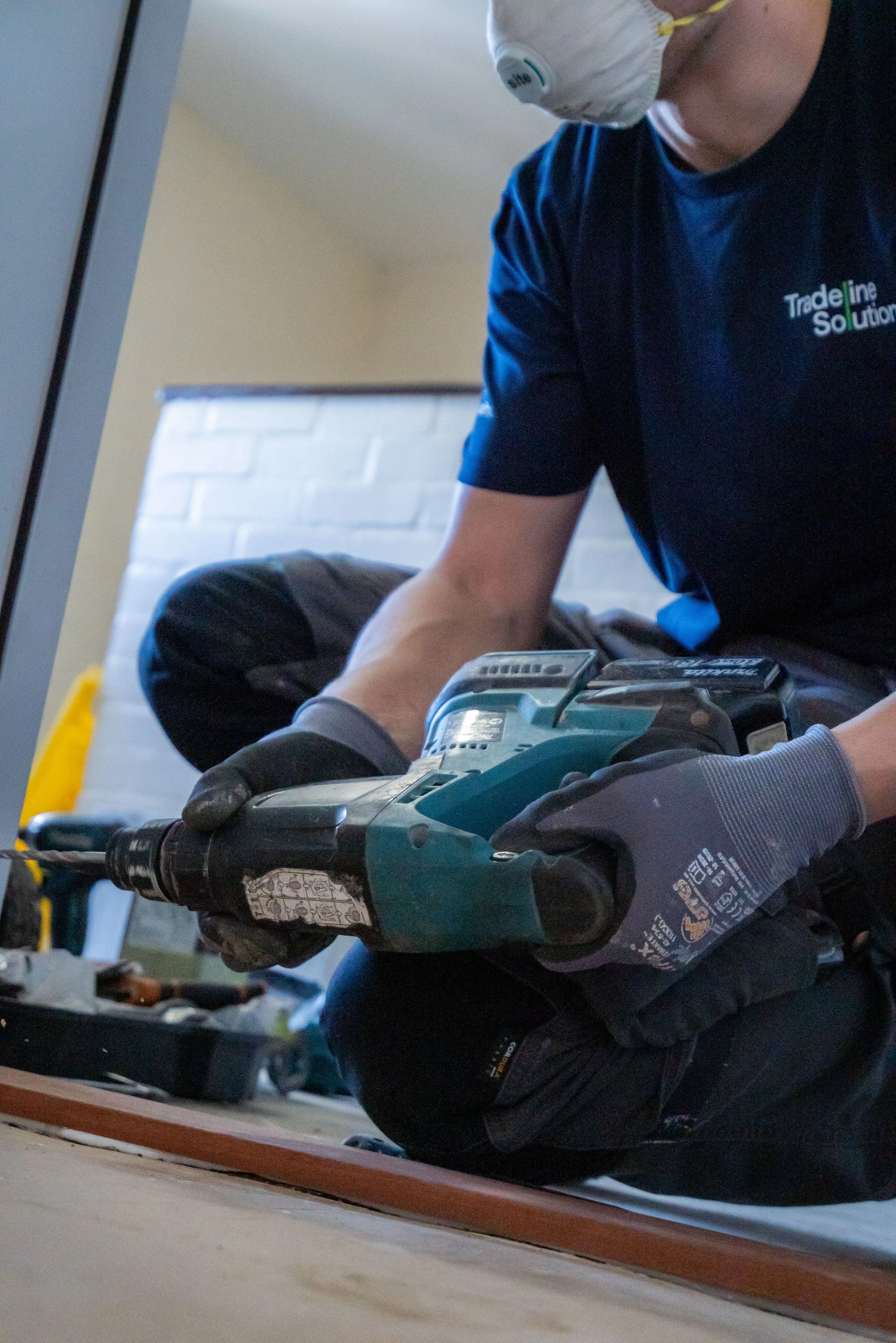 Construction worker measuring window frame in a building.