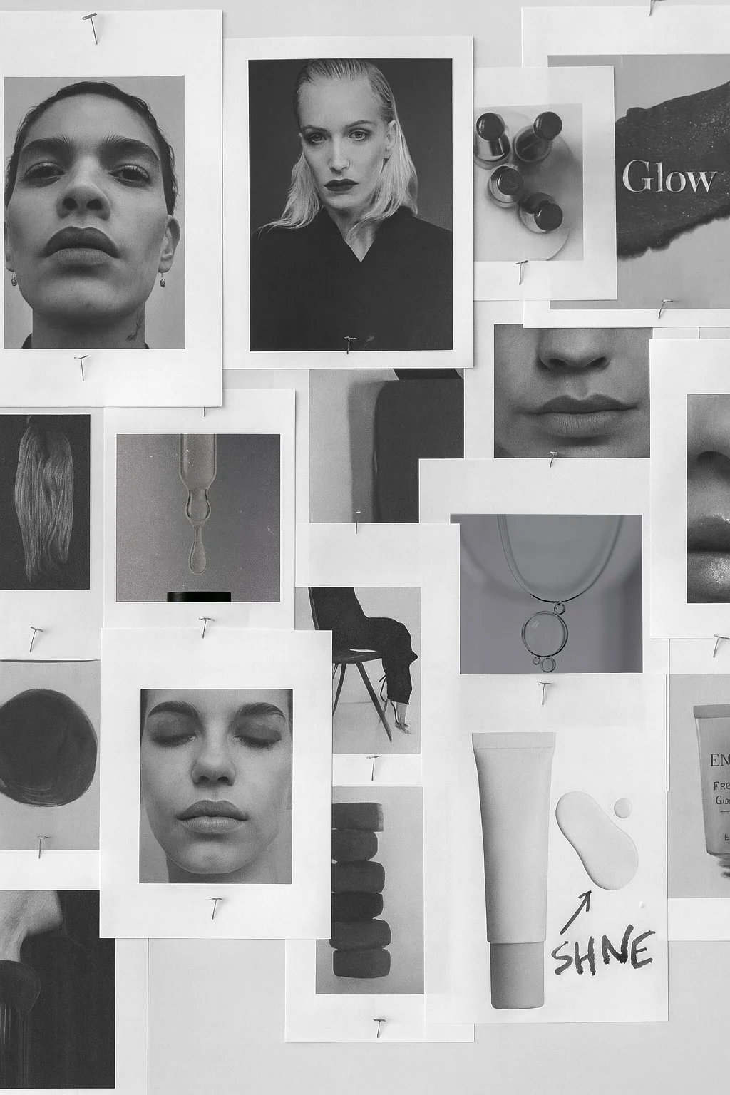Black and white collage of fashion and beauty photography, including portraits of women with makeup, earrings, necklaces, and skincare products, pinned to a wall with safety pins.