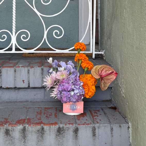 Monthly flower delivery arrangement on a front step