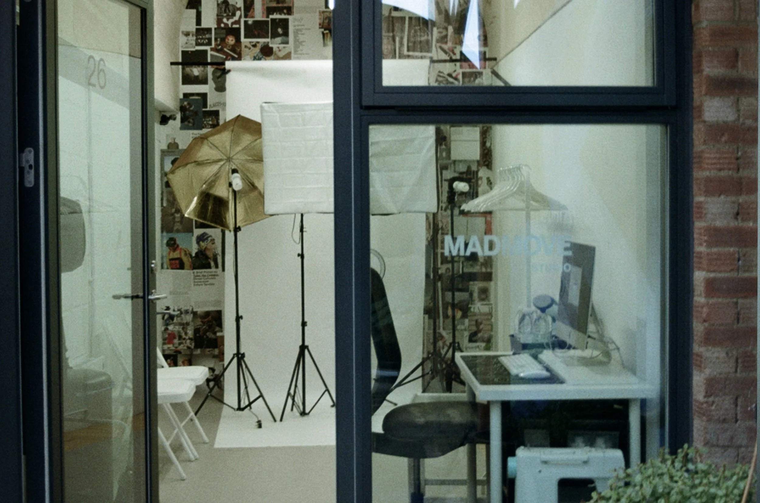 Scenic view of a large water body with mountain ranges in the background and rolling green hills and grassland in the foreground under a cloudy sky.