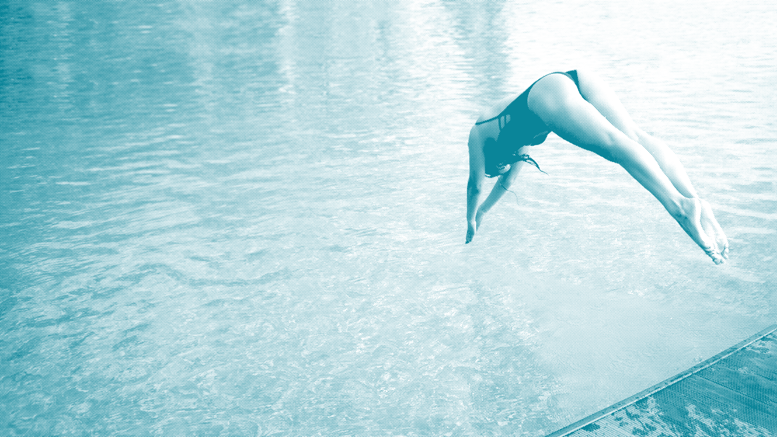 A person performing a backbend yoga pose outdoors near a body of water, with their hands on the ground and legs extended back.